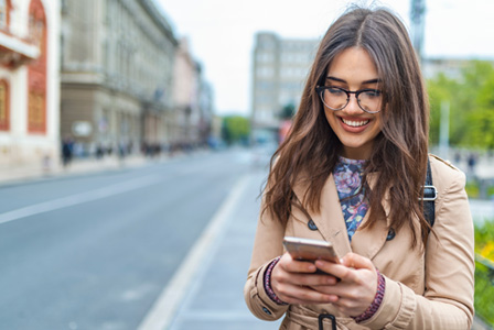 woman smiling at phone